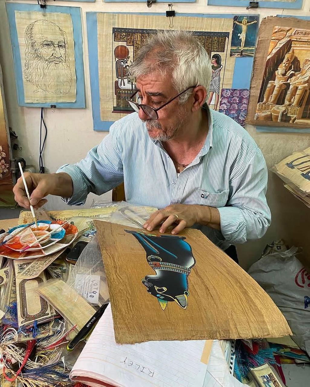 Artist painting papyrus