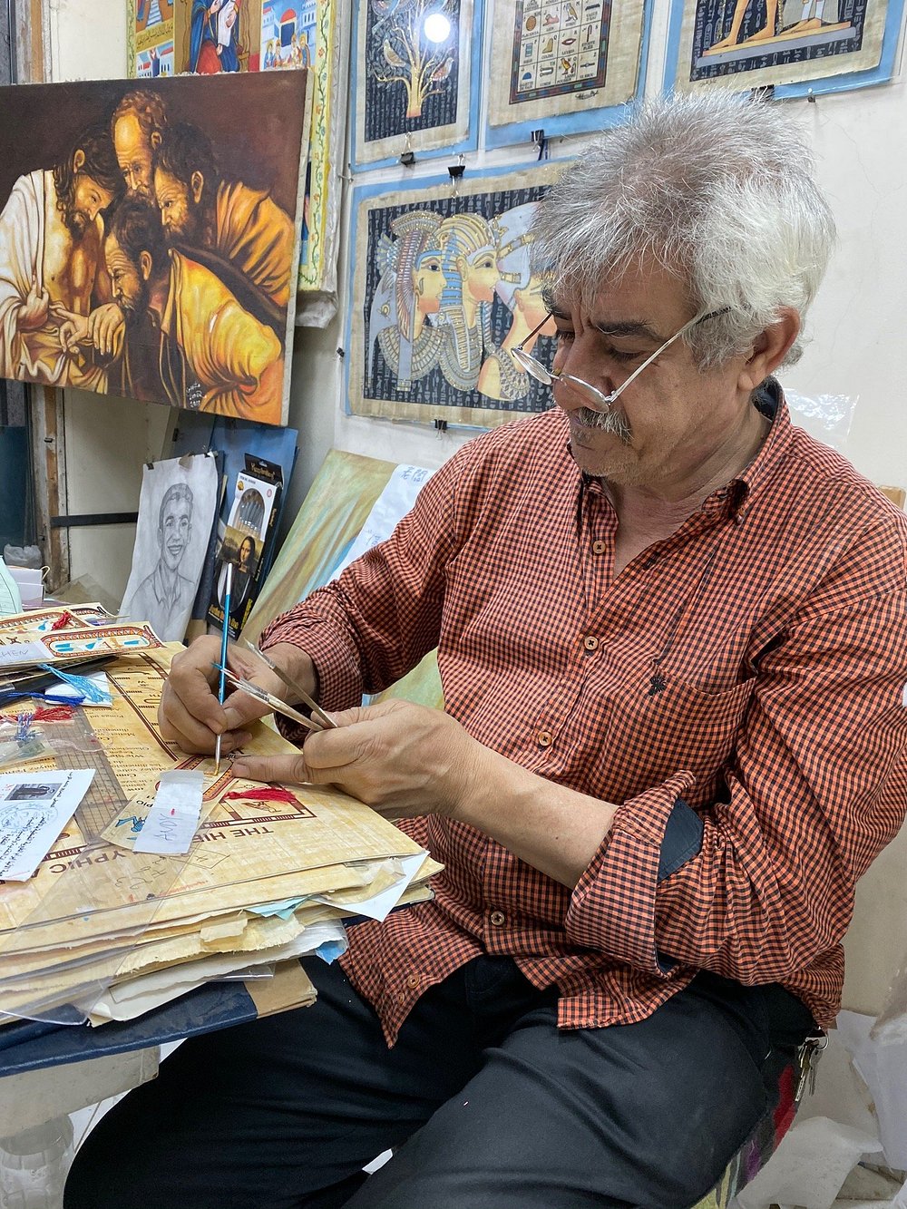 Artist painting at desk